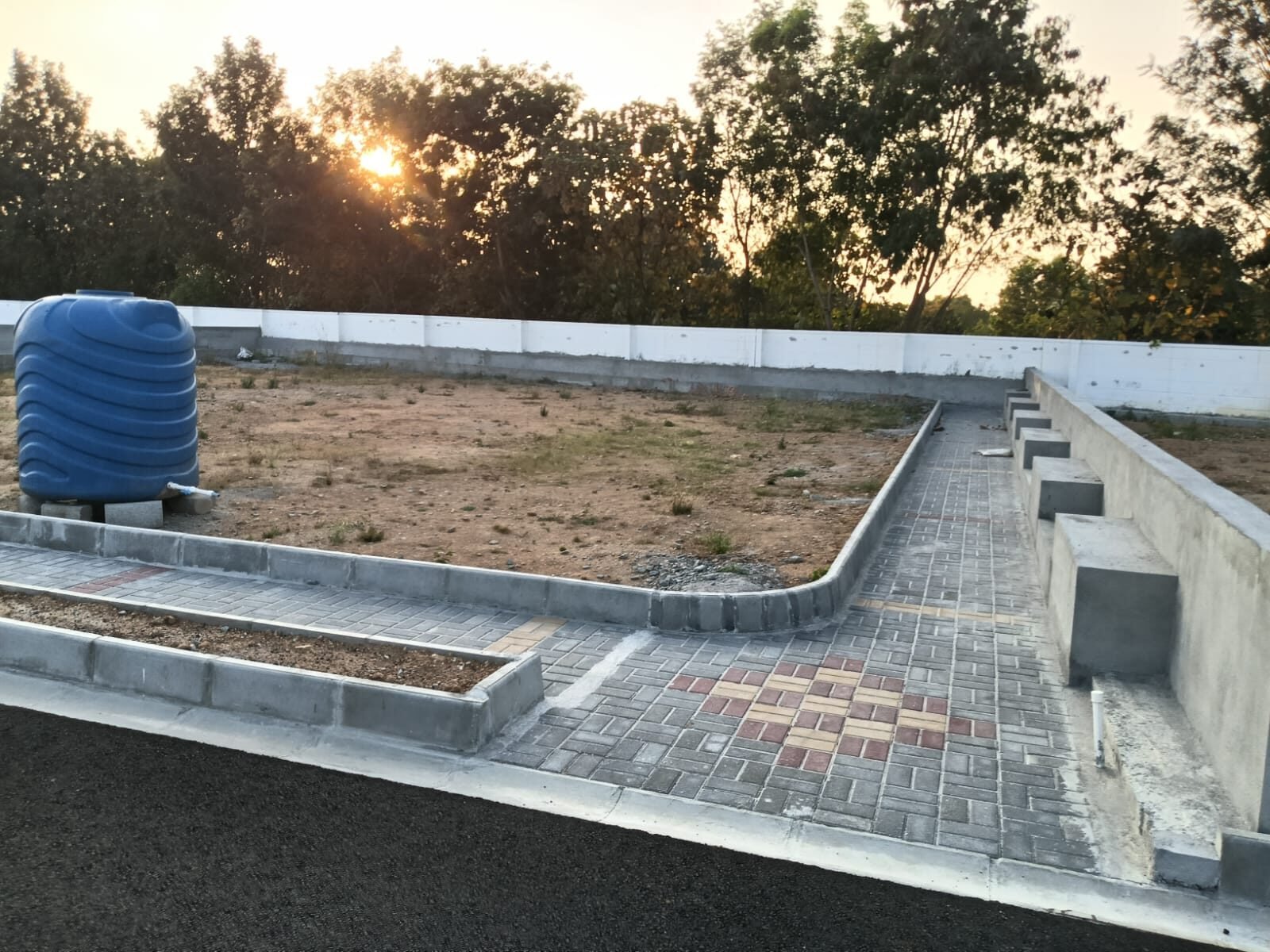 AVS Royal Encasa - Plot with water connection and decorative paver pathway at sunset